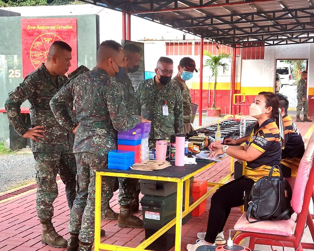 Group of Marine Corps huddled around registration table