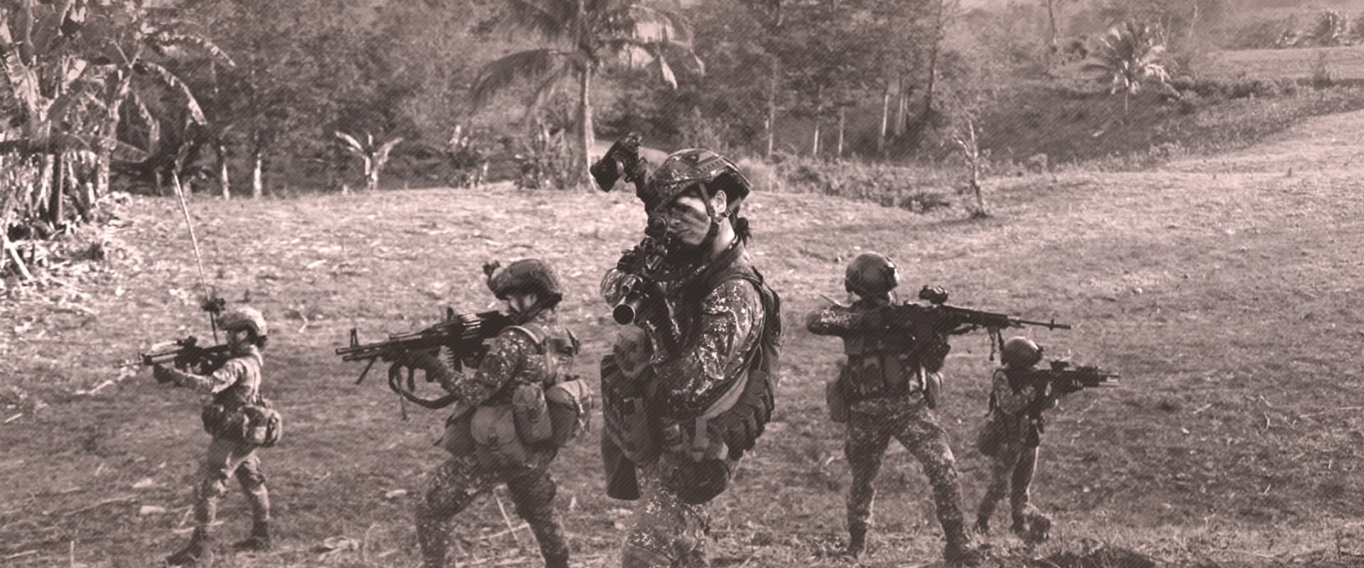 5 Female Marine Corps with full combat gear in a military pose, holding their rifles.